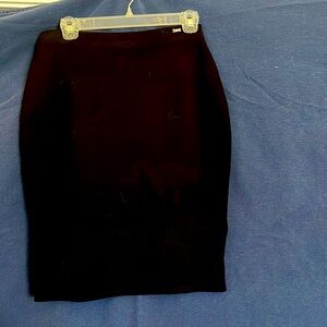 St. John size M black pencil skirt with cut outs on the bottom side slit